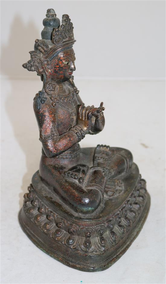 A Sino-Tibetan lacquered bronze seated figure of a Bodhisattva, 16th/17th century, height 23cm